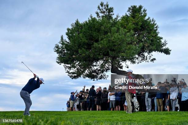 Jon Rahm of Spain hits from the rough of the sixth hole after an errant shot while playing the second hole during the final round of The Farmers...