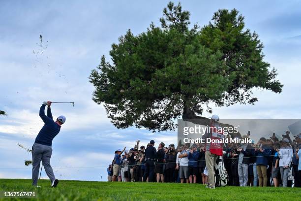 Jon Rahm of Spain hits from the rough of the sixth hole after an errant shot while playing the second hole during the final round of The Farmers...