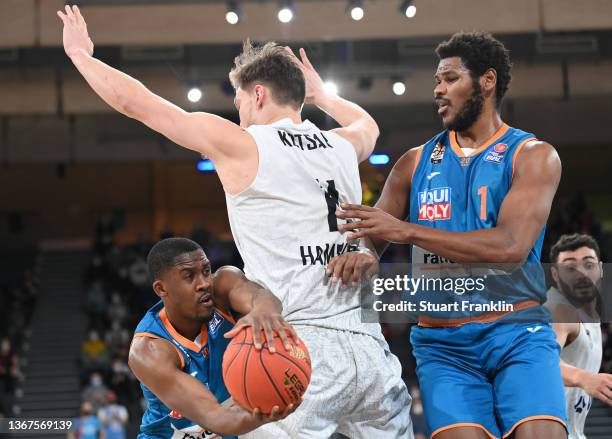 Semja Christon and Cristiano Felicio of Ulm challenge Maik Kostar of Hamburg during the BBL game between Hamburg Towers and Ratiopharm Ulm at...