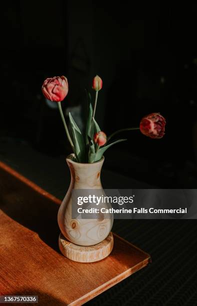 simple and pretty wooden vase on a wooden table, containing pink tulips. - grooved stock pictures, royalty-free photos & images
