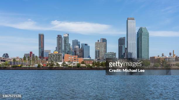 view of long island city towers from roosevelt island - new york - queensday stock-fotos und bilder