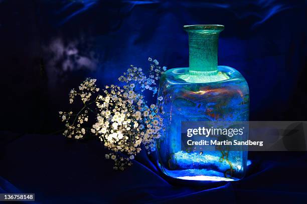 bottle full of light - blue glass stock pictures, royalty-free photos & images