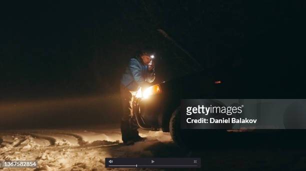 man with car issues on winter road, phone calling for help. - roadside challenge stock pictures, royalty-free photos & images