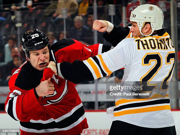 Shawn Thornton of the Boston Bruins fights with Cam Janssen of the New Jersey Devils during an NHL hockey game at Prudential Center on January 4,...