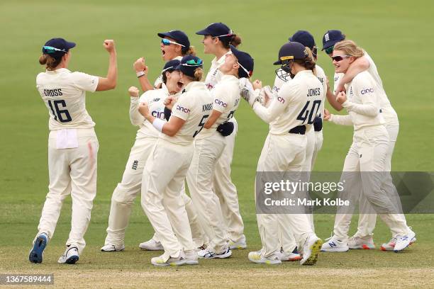 Charlie Dean of England celebrates with her team after the DRS confirms the wicket of Beth Mooney of Australia during day four of the Women's Test...