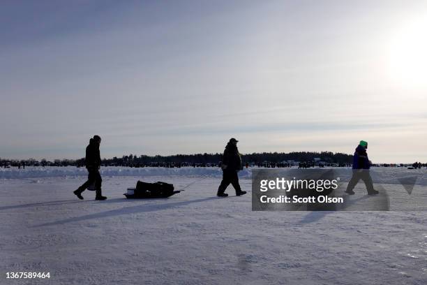 Fishermen head off of the ice at Gull Lake following the Brainerd Jaycees Ice Fishing Extravaganza on January 29, 2022 in Brainerd, Minnesota. About...