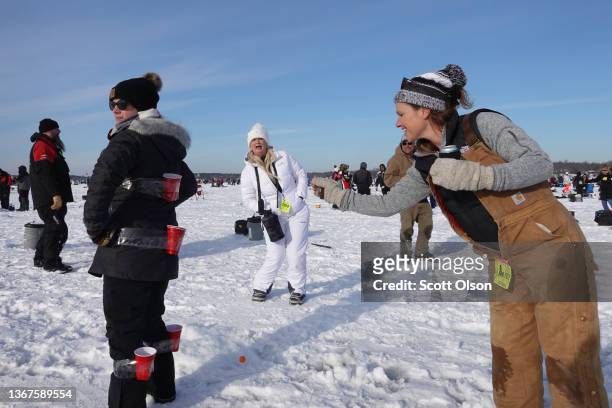 Fishermen play a modified version of beer pong while they compete in the Brainerd Jaycees Ice Fishing Extravaganza on January 29, 2022 in Brainerd,...