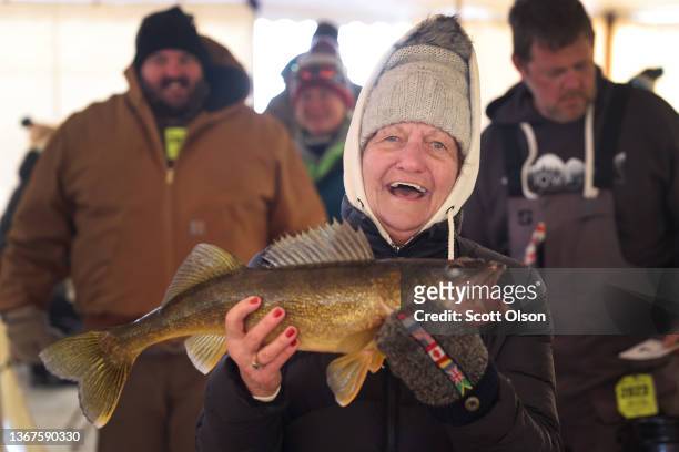 Kate Spangler brings in her 4.47 pound walleye to be weighed during the Brainerd Jaycees Ice Fishing Extravaganza on January 29, 2022 in Brainerd,...