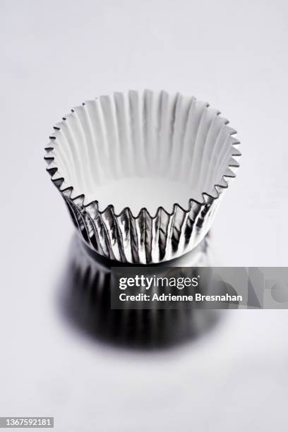 silver foil cupcake wrapper - cake case stock pictures, royalty-free photos & images