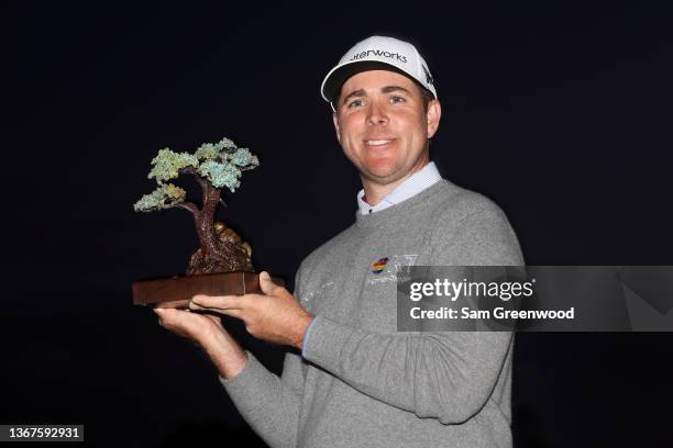 Luke List celebrates with the trophy after winning the The Farmers Insurance Open at Torrey Pines Golf Course on January 29, 2022 in La Jolla,...