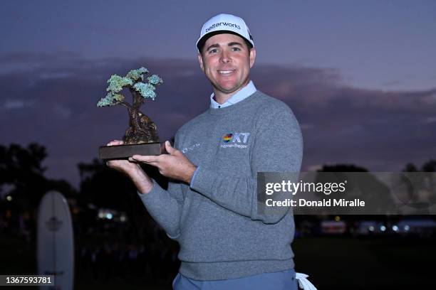 Luke List celebrates with the trophy after winning the The Farmers Insurance Open at Torrey Pines Golf Course on January 29, 2022 in La Jolla,...