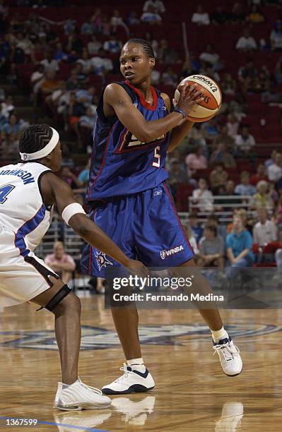 Elaine Powell of the Detroit Shock is defended by Shannon Johnson of the Orlando Miracle during the game on August 11, 2002 at TD Waterhouse Centre...