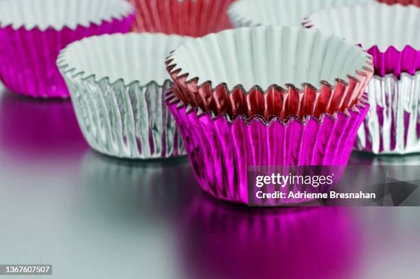 pink and silver foil cupcake wrappers - candy wrapper stock pictures, royalty-free photos & images