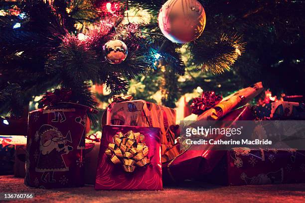 brightly wrapped christmas presents - catherine macbride stock pictures, royalty-free photos & images