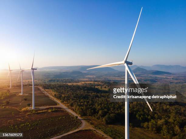panoramic view of wind farm or wind park, with high wind turbines for generation electricity with copy space. green energy concept. - wind mill fotografías e imágenes de stock