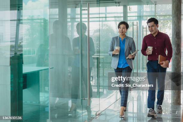 asian business people colleagues working together discussing while walking at modern office corridor, business partners teamwork - businessmen casual not phone walking stock pictures, royalty-free photos & images