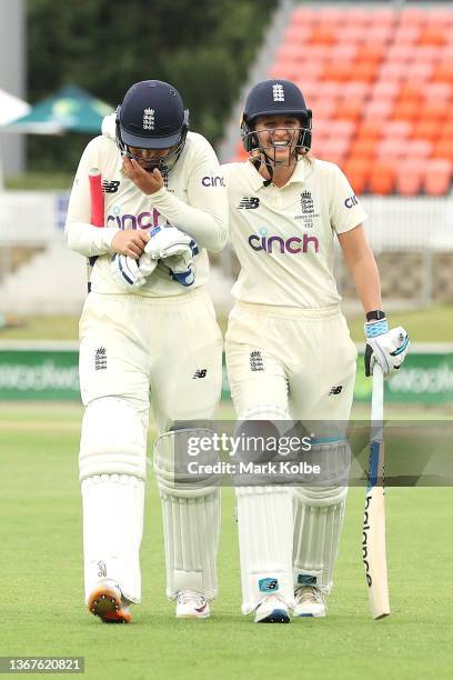 Sophie Ecclestone and Kate Cross of England leave the field after the match finished in a draw during day four of the Women's Test match in the Ashes...