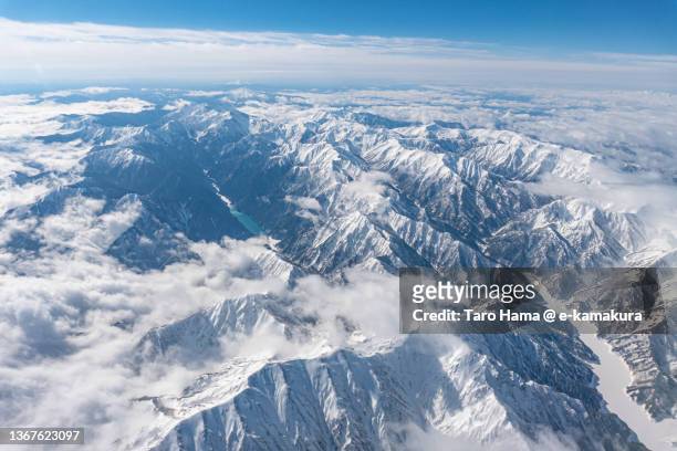 snowcapped hida mountains in nagano of japan aerial view from airplane - toyama prefecture stock pictures, royalty-free photos & images