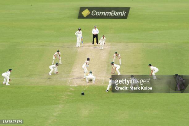 The Australian team surround the bat as Kate Cross of England blocks out the final ball for the match to finish in a draw during day four of the...