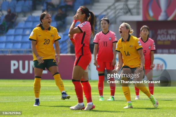 Cho So Hyon of South Korea reacts after missing a penalty kick while Sam Kerr and Alanna Kennedy of Australia celebrate during the AFC Women's Asian...