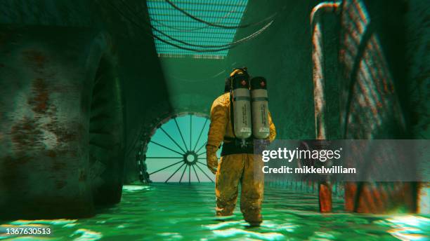 worker in radiation protection suit walks through green water in destroyed factory - nuclear waste management stock pictures, royalty-free photos & images