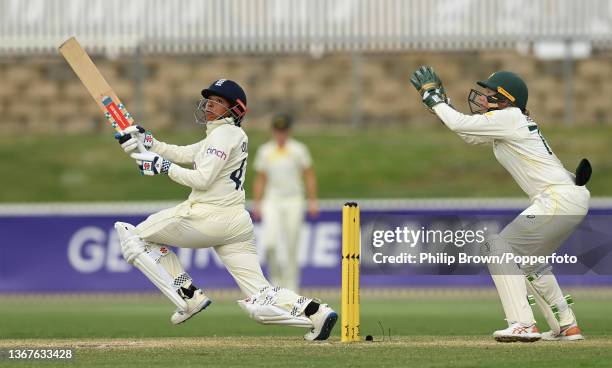 Sophia Dunkley of England bats watched by Alyssa Healy of Australia during day four of the Women's Test match in the Ashes series between Australia...