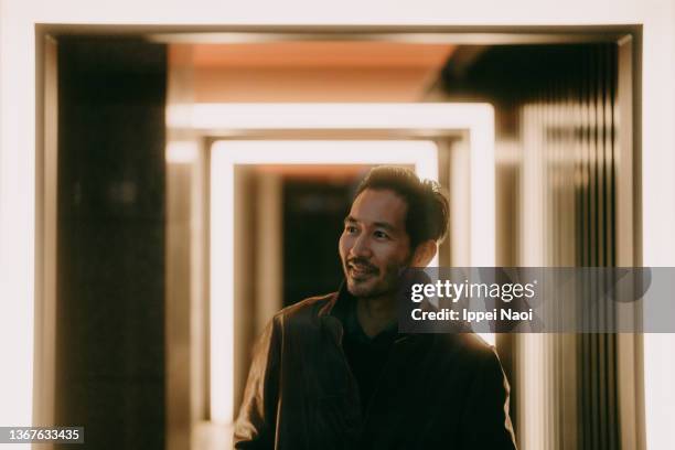 cheerful man on alleyway with lights - led street lighting stockfoto's en -beelden