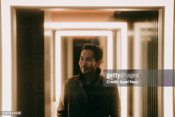 man on alleyway with lights - led street lighting stockfoto's en -beelden