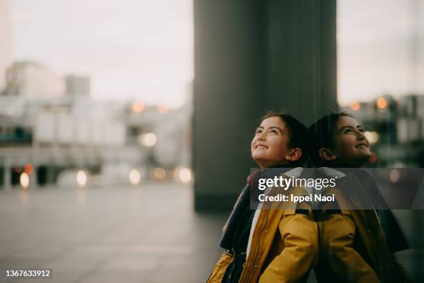 cheerful young girl in city in winter at dusk - center street elementary - fotografias e filmes do acervo