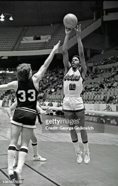 Guard Norm Nixon of the Duquesne University Dukes shoots the basketball against the Penn State University Nittany Lions during a college basketball...