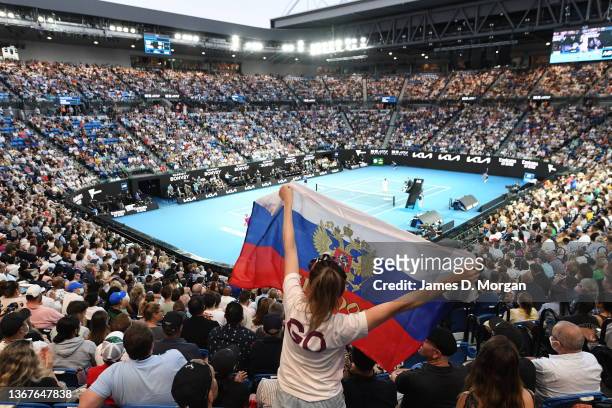 Fan holds up the Russia flag on Rod Laver Arena during the Men's Singles Final match between Rafael Nadal of Spain and Daniil Medvedev of Russia...
