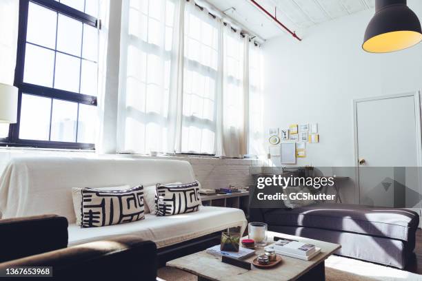 comfortable seating arrangement in a loft - studio apartment stock pictures, royalty-free photos & images