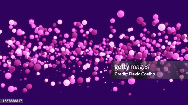 pink spheres on purple background - particle sphere stock pictures, royalty-free photos & images