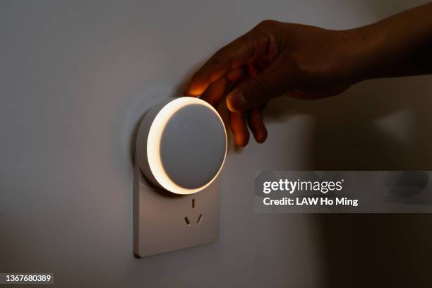 an asian male is installing an automatic sensor light for smart homes - power point foto e immagini stock