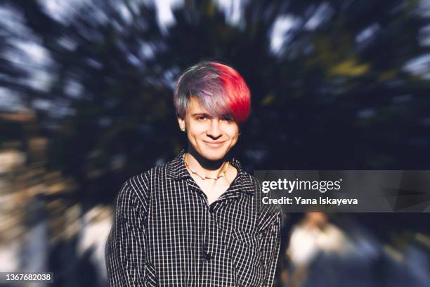 sunlit portrait of a young attractive man with colored hair - violet manners stock pictures, royalty-free photos & images