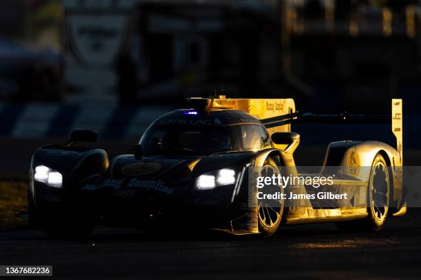 The JDC Miller MotorSports Cadillac DPi of Richard Westbrook, Tristan Vautier, Loic Duval, and Ben Keating drives during sunrise at the Rolex 24 at...