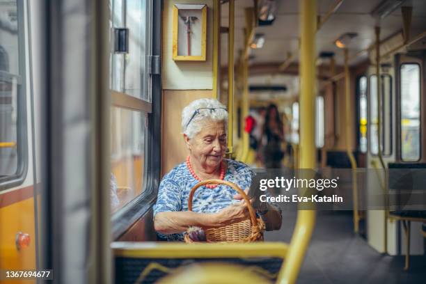 senior woman in the city - public transportation stockfoto's en -beelden