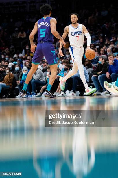 Amir Coffey of the Los Angeles Clippers brings the ball up court while guarded by James Bouknight of the Charlotte Hornets in the first quarter...