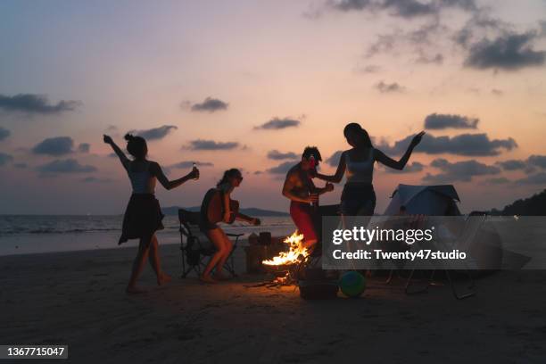 group of asian friends having fun enjoying beach camping in summer - party beach stockfoto's en -beelden