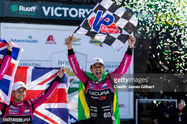 Helio Castroneves of Brazil, driver of the Meyer Shank Racing w/ Curb-Agajanian Acura DPi celebrates with his team in victory lane after winning the...