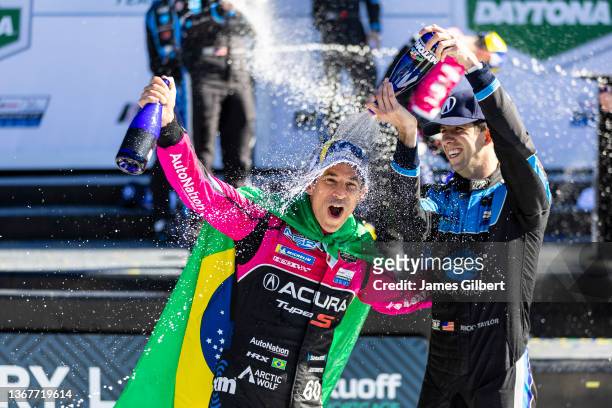 Helio Castroneves, driver of the Meyer Shank Racing w/ Curb-Agajanian Acura DPi celebrates with Ricky Taylor, driver of the Konica Minolta Acura...