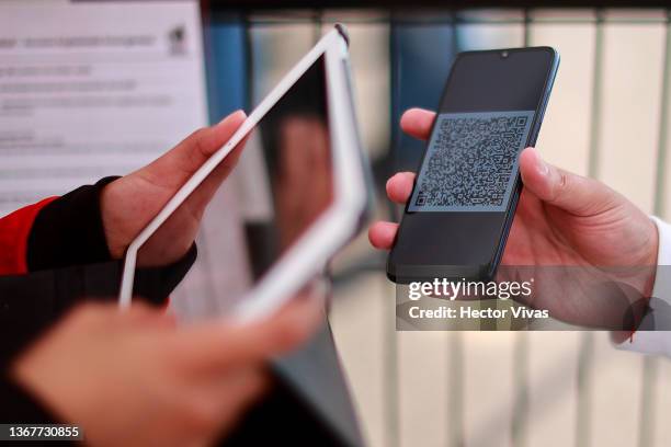 Fan shows a QR code to be able to enter with prior registration to the ticket prior the match between Mexico and Costa Rica as part of the Concacaf...