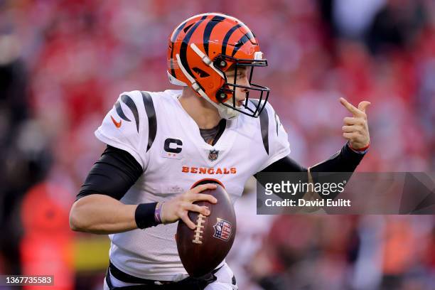 Quarterback Joe Burrow of the Cincinnati Bengals rolls out to pass against the Kansas City Chiefs during the second half of the AFC Championship Game...
