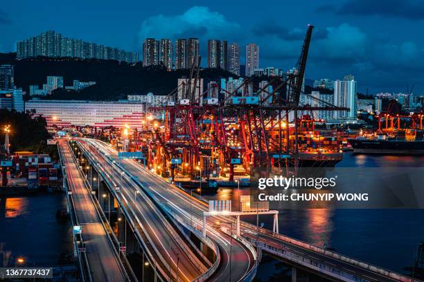 cargo terminal traffic in city at night - kwai tsing stock pictures, royalty-free photos & images