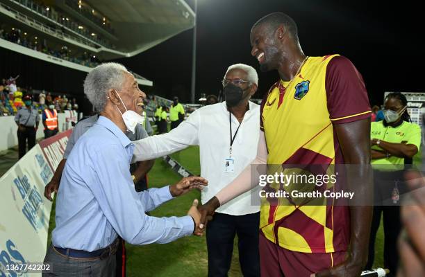 Jason Holder of the West Indies celebrates shakes hands with Garfield Sobers winning the 5th T20 International match between West Indies and England...