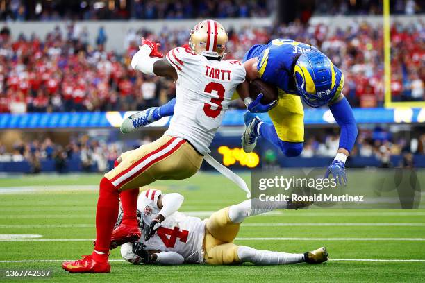 Tyler Higbee of the Los Angeles Rams is tackled after a catch by Jaquiski Tartt of the San Francisco 49ers in the first quarter in the NFC...