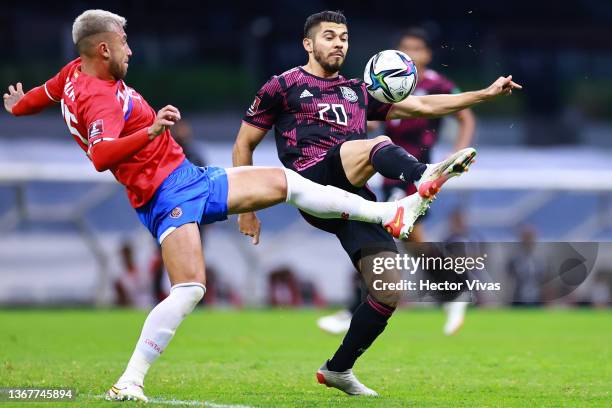 Francisco Calvo of Costa Rica competes for the ball with Henry Martin of Mexico during the match between Mexico and Costa Rica as part of the...