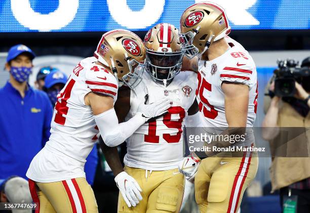 Deebo Samuel of the San Francisco 49ers reacts with teammates Kyle Juszczyk and George Kittle after scoring a touchdown in the second quarter against...