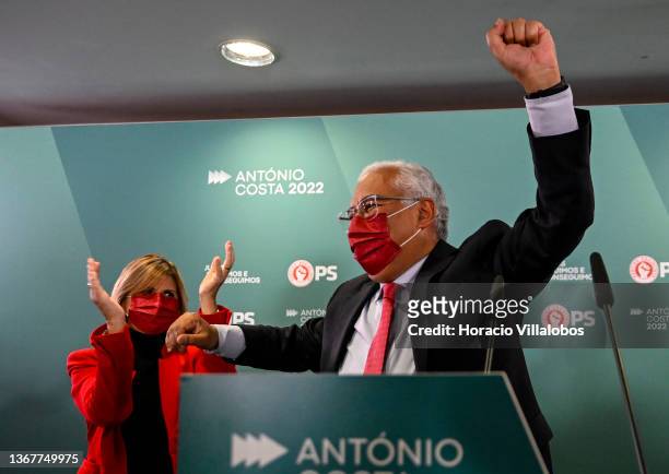 Portuguese Prime Minister and Secretary General of the Socialist Party Antonio Costa raises a fist in celebration while being applauded by his wife...
