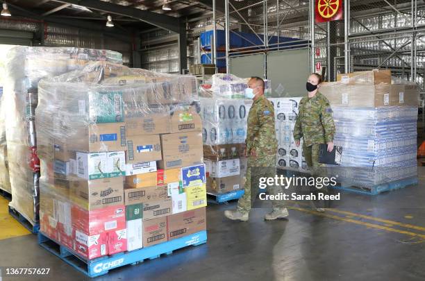 Aircraft crew who were asked to stand amongst the palettes of supplies that are waiting to be loaded onto the plan on January 31, 2022 in Adelaide,...